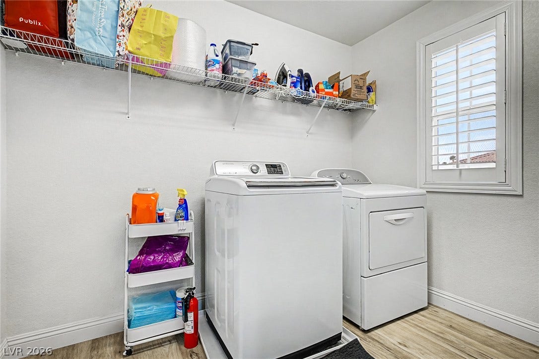 Functional laundry space featuring modern appliances and practical storage solutions.