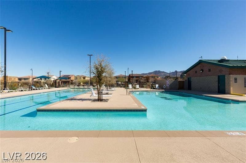 A spacious community swimming pool offers ample room for recreation under clear blue skies.