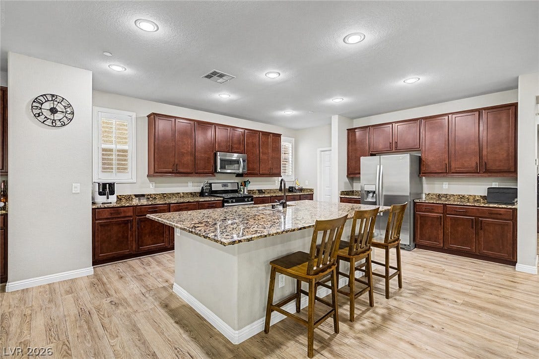 A chef's dream kitchen with rich wood cabinetry, abundant counter space, and a generous central island.
