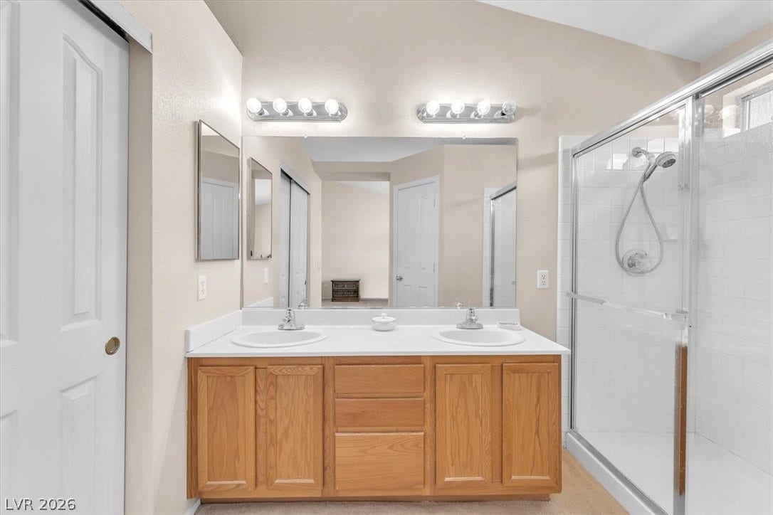 1163 Teal Point Drive, Henderson, NV 89074 Bathroom featuring a sink, a shower stall, and double vanity