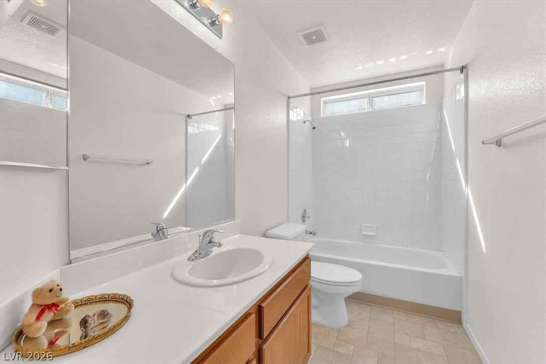 1163 Teal Point Drive, Henderson, NV 89074 Bathroom featuring visible vents, a textured ceiling, toilet, and vanity