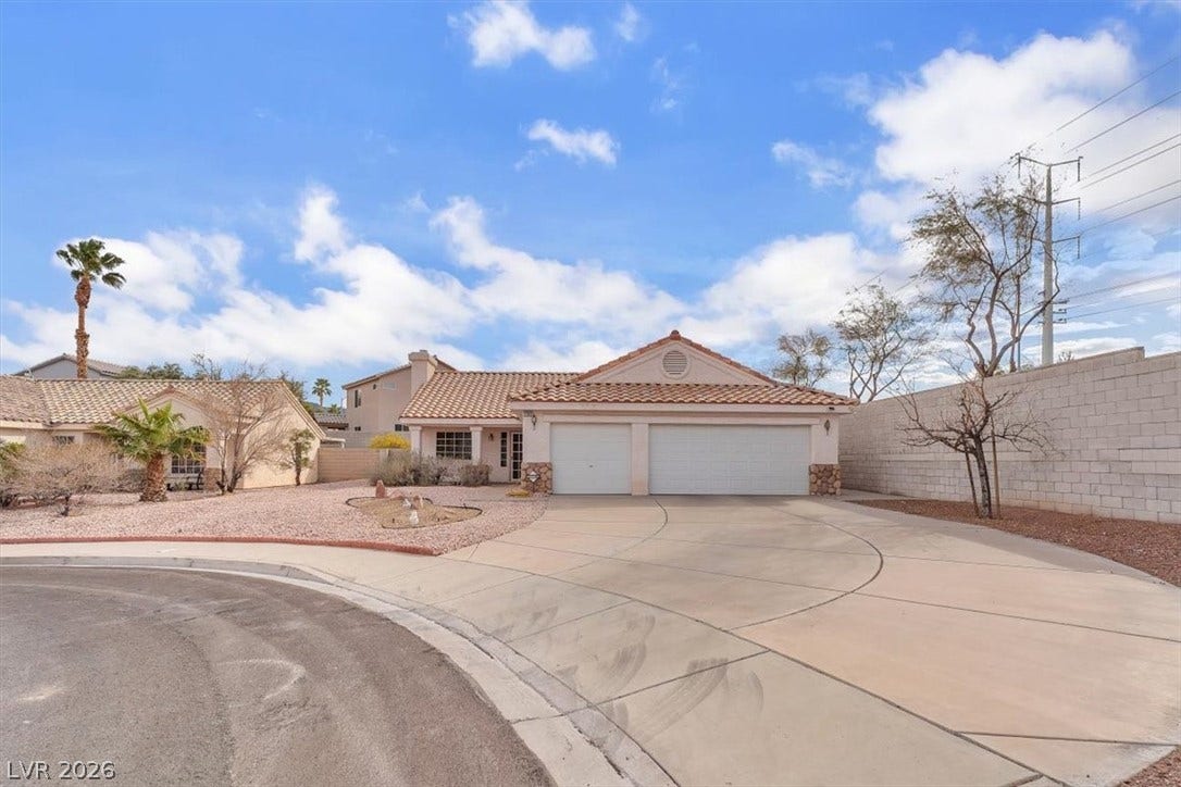 1163 Teal Point Drive, Henderson, NV 89074 Mediterranean / spanish-style house featuring a tile roof, stucco siding, an attached garage, fence, and driveway