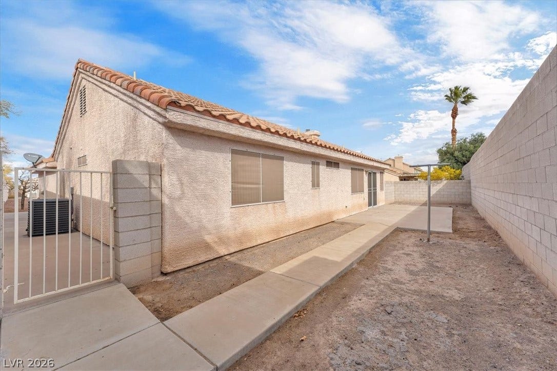 1163 Teal Point Drive, Henderson, NV 89074 View of side of home featuring a fenced backyard, a tiled roof, a patio, and stucco siding