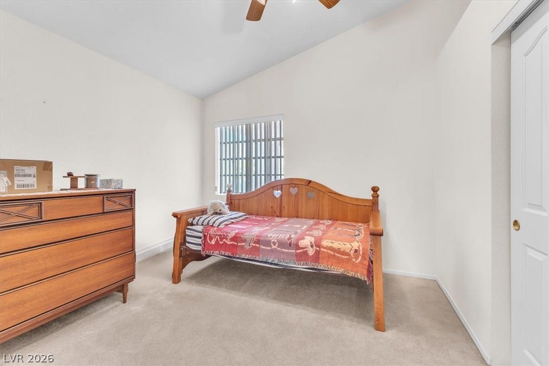 1163 Teal Point Drive, Henderson, NV 89074 Bedroom featuring vaulted ceiling, light carpet, a ceiling fan, and baseboards