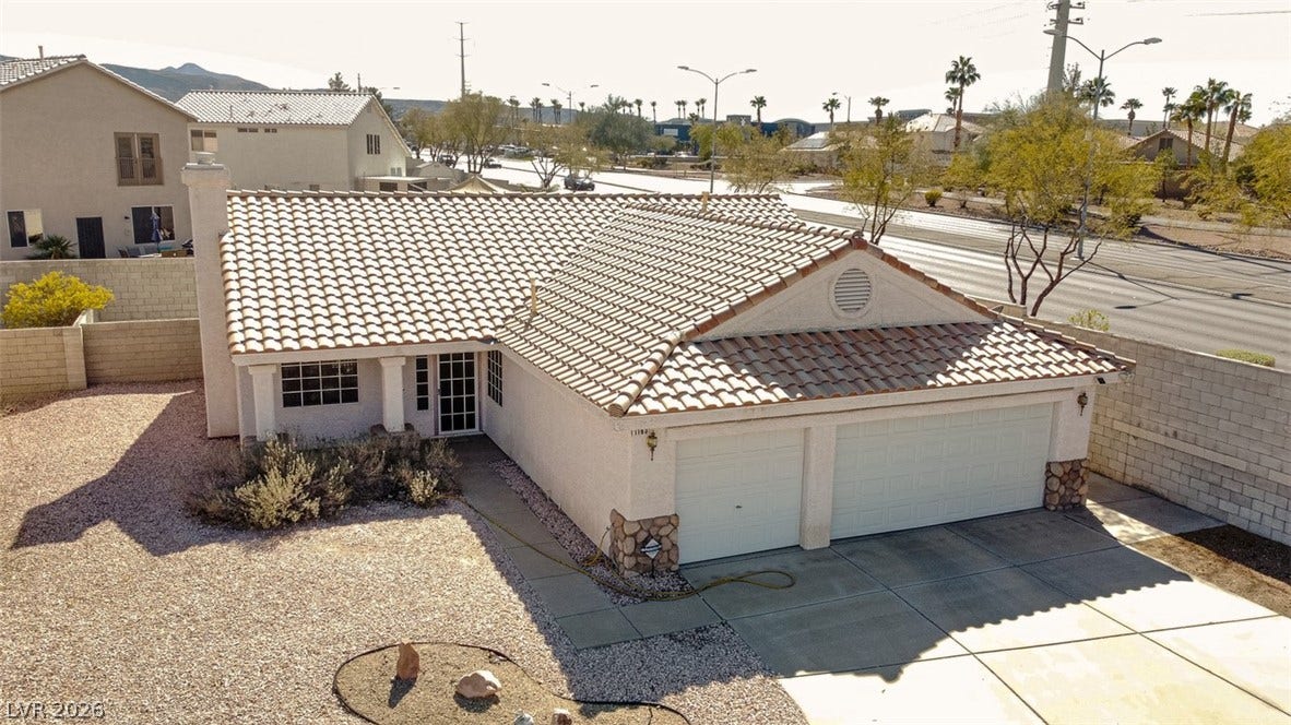 1163 Teal Point Drive, Henderson, NV 89074 Mediterranean / spanish-style house featuring a garage, driveway, a tile roof, and stucco siding