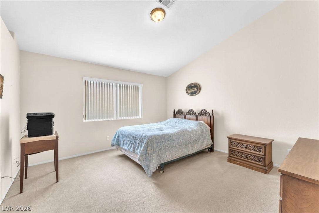 1163 Teal Point Drive, Henderson, NV 89074 Bedroom with lofted ceiling, carpet floors, visible vents, and baseboards