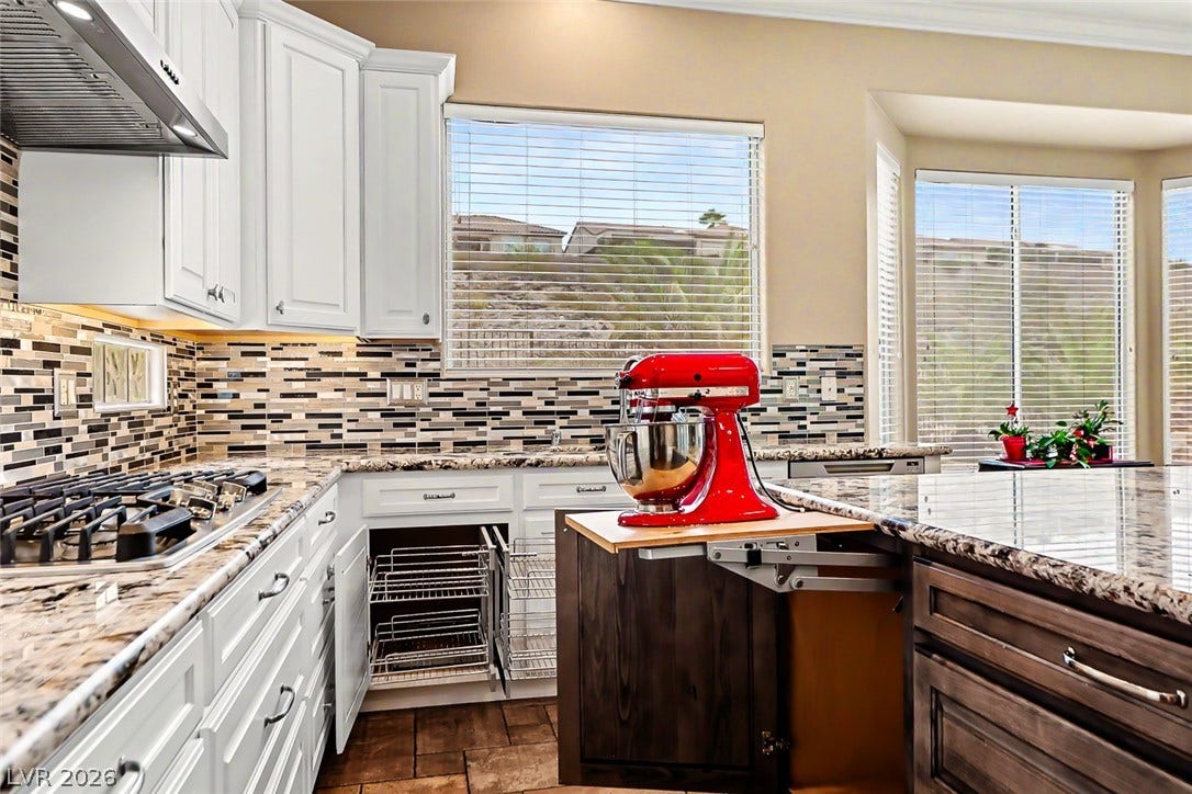 2306 Schaeffer Hills Drive, Henderson, NV 89052 A well-appointed kitchen showcasing elegant granite countertops and modern appliances.