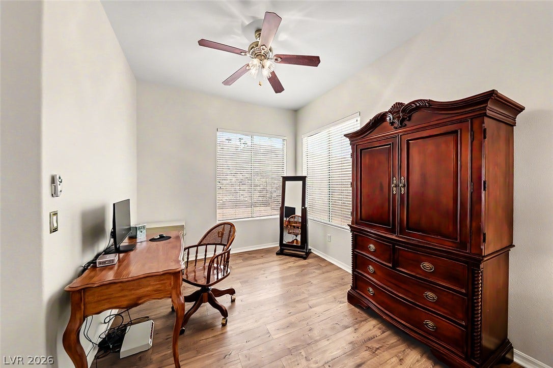 2306 Schaeffer Hills Drive, Henderson, NV 89052 A versatile home office with rich hardwood flooring and sun-filled windows.