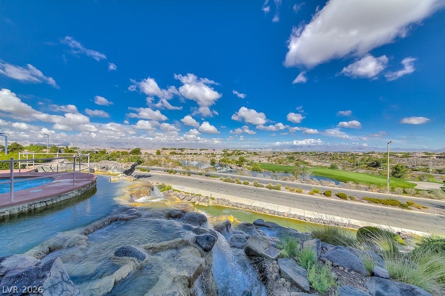 2306 Schaeffer Hills Drive, Henderson, NV 89052 Lush landscaping and flowing water features enhance a scenic view of the golf course.