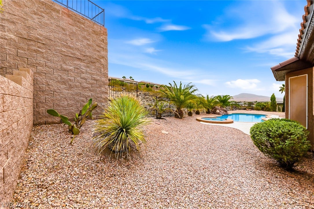 2306 Schaeffer Hills Drive, Henderson, NV 89052 A desert oasis with a sparkling pool and spa, framed by native landscaping and panoramic mountain views.