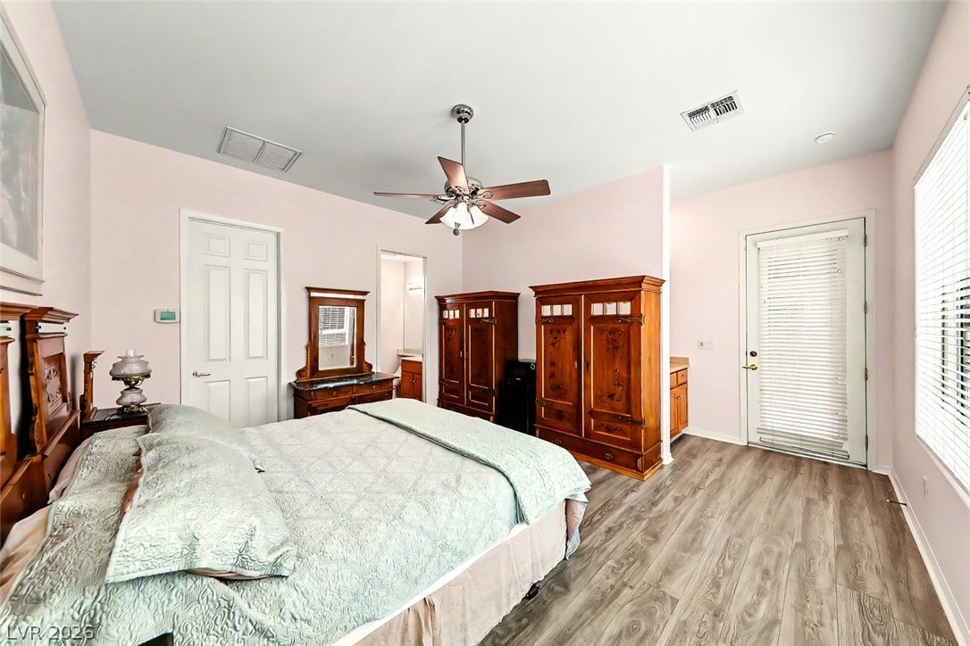 2306 Schaeffer Hills Drive, Henderson, NV 89052 Hardwood-style flooring and a ceiling fan create a comfortable atmosphere in this well-appointed bedroom.