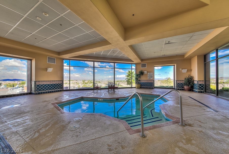2306 Schaeffer Hills Drive, Henderson, NV 89052 An indoor spa retreat awaits, offering a tranquil soak with picturesque outdoor views.