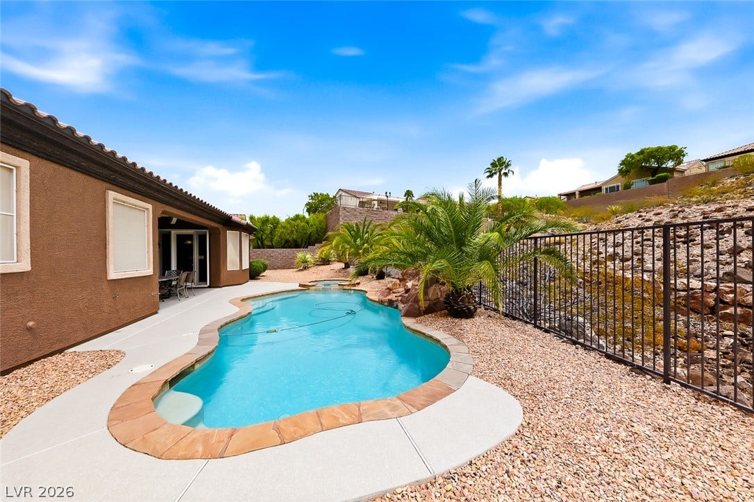 2306 Schaeffer Hills Drive, Henderson, NV 89052 A private swimming pool with stone coping and a spacious patio area creates an ideal desert oasis.
