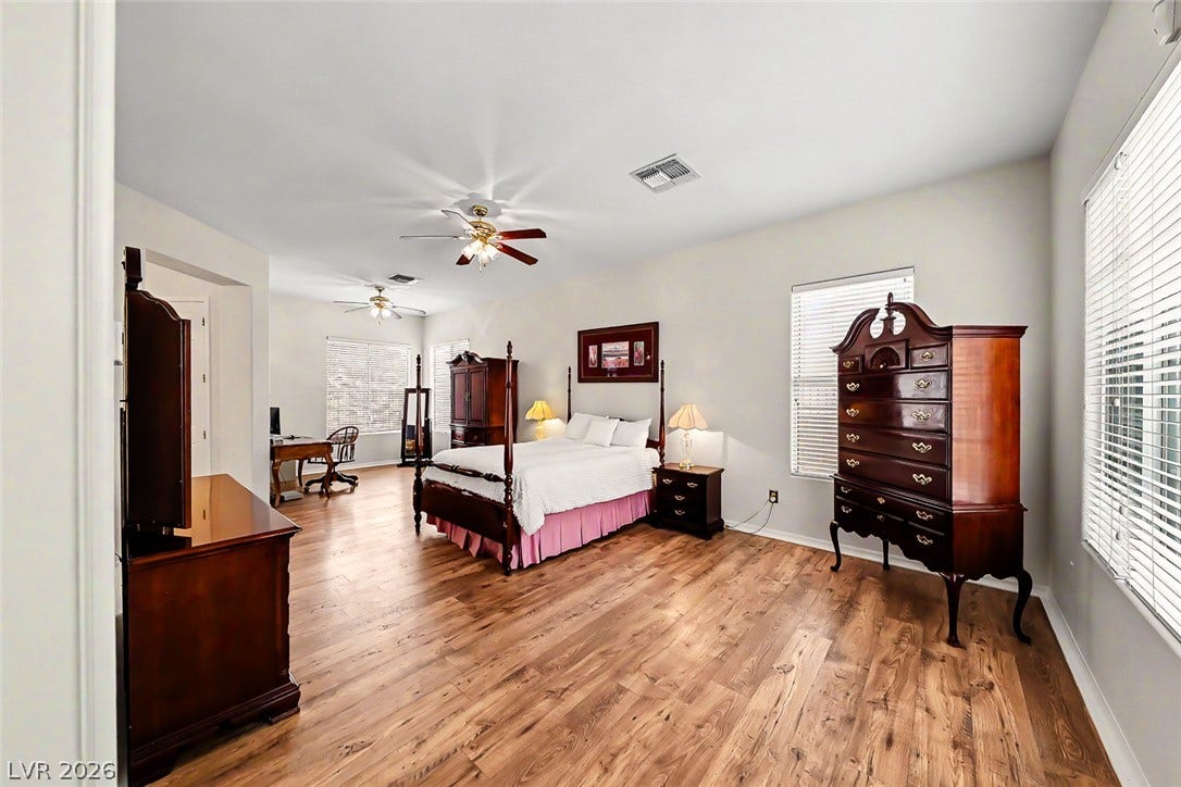 2306 Schaeffer Hills Drive, Henderson, NV 89052 A spacious sleeping area offers warm wood flooring and abundant natural light.