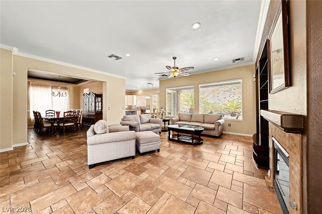 2306 Schaeffer Hills Drive, Henderson, NV 89052 A spacious common area with a view of the dining room and an open-concept layout perfect for entertaining.