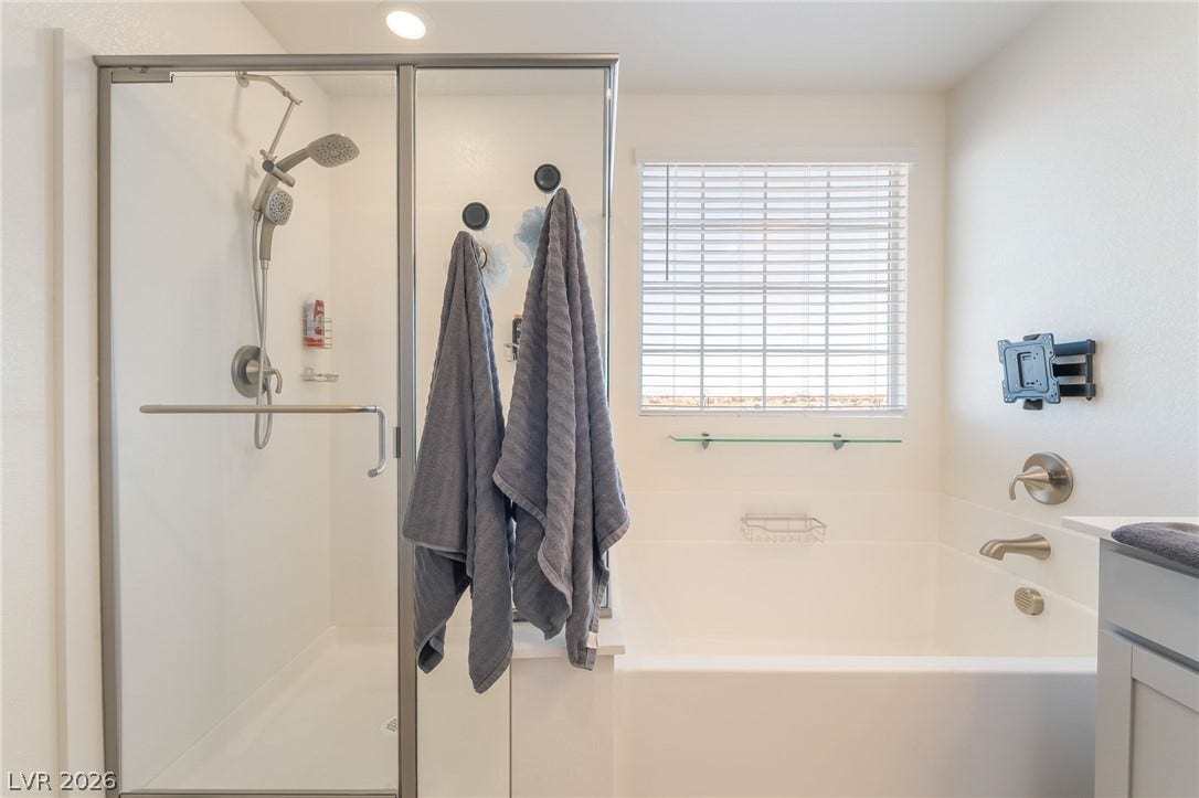 2966 Gallarate Drive, Henderson, NV 89044 A well-appointed bath features a spacious shower enclosure and a generous soaking tub, offering both convenience and comfort.