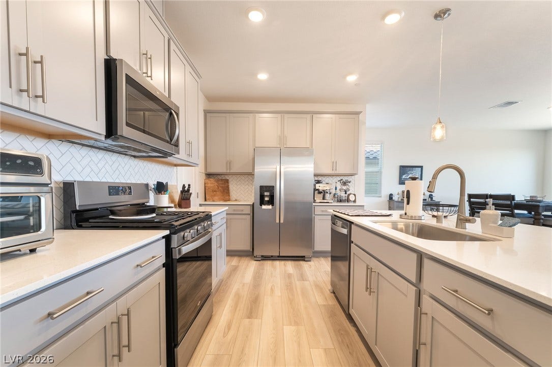 2966 Gallarate Drive, Henderson, NV 89044 A well-appointed culinary space featuring sleek stainless steel appliances and abundant cabinetry.