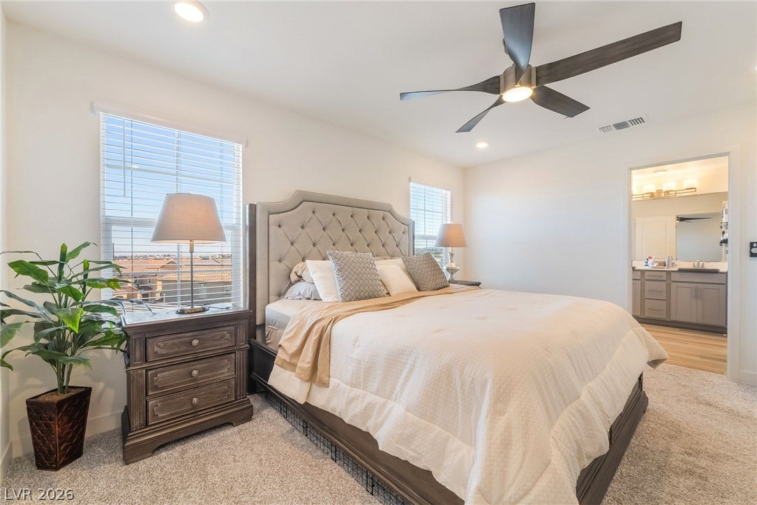 2966 Gallarate Drive, Henderson, NV 89044 A tranquil primary bedroom with plush carpeting offers direct access to a well-appointed private bathroom.
