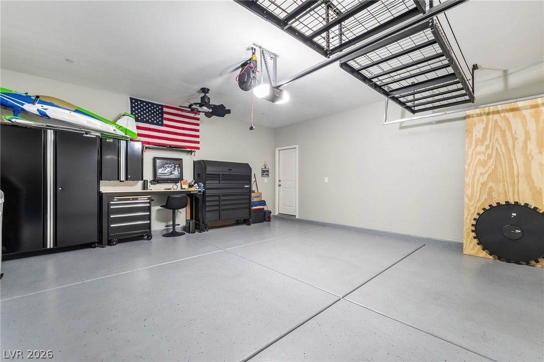 2966 Gallarate Drive, Henderson, NV 89044 Ample garage space with overhead storage and dedicated workspace provides versatile utility.