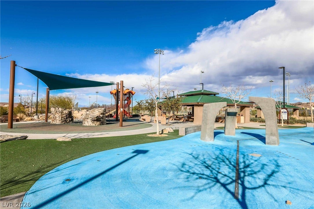 2966 Gallarate Drive, Henderson, NV 89044 A vibrant community park with a playful splash pad, shaded seating, and engaging playground equipment.