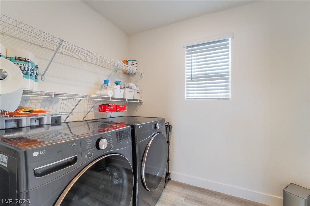 2966 Gallarate Drive, Henderson, NV 89044 Functional laundry room offers convenient shelving and modern appliances for efficient chores.