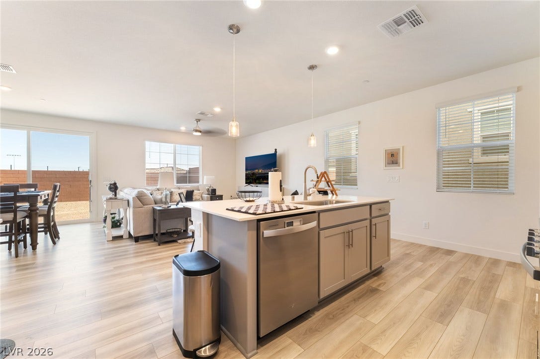 2966 Gallarate Drive, Henderson, NV 89044 An open-concept living space integrates a well-appointed kitchen island, creating a harmonious flow for daily living.
