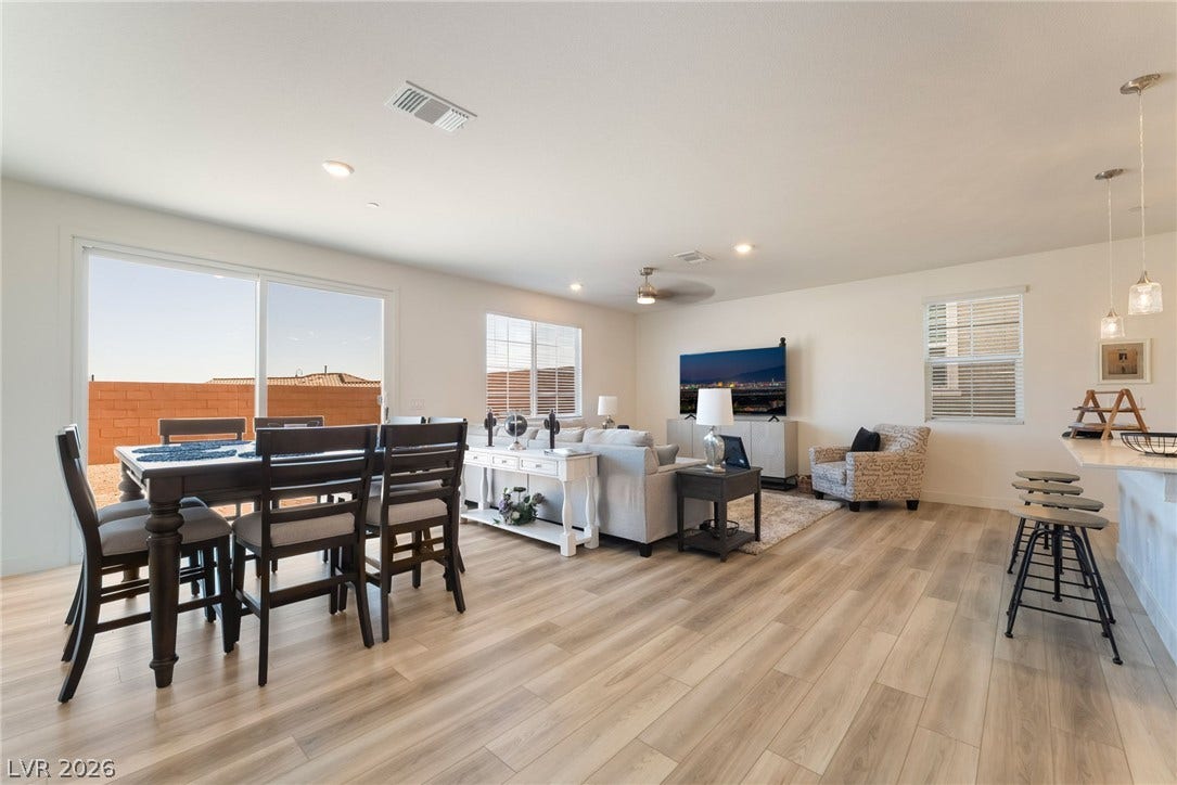 2966 Gallarate Drive, Henderson, NV 89044 Natural light illuminates this inviting living space, featuring an open layout, dining area, and sliding glass doors.
