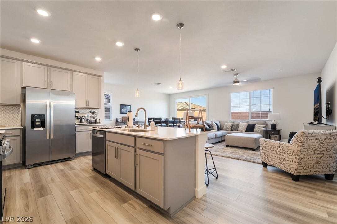 2966 Gallarate Drive, Henderson, NV 89044 A well-lit, open-concept kitchen flows seamlessly into the living space, creating an inviting atmosphere.