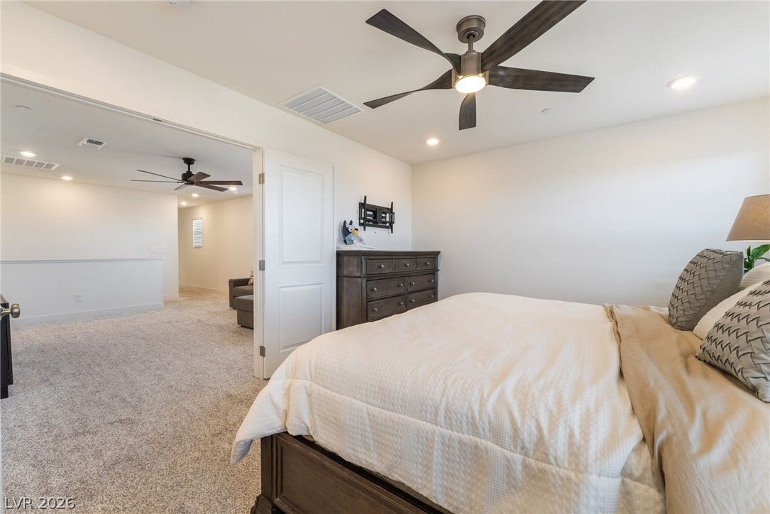 2966 Gallarate Drive, Henderson, NV 89044 A quiet bedroom retreat features plush carpet and recessed lighting, creating a serene ambiance.