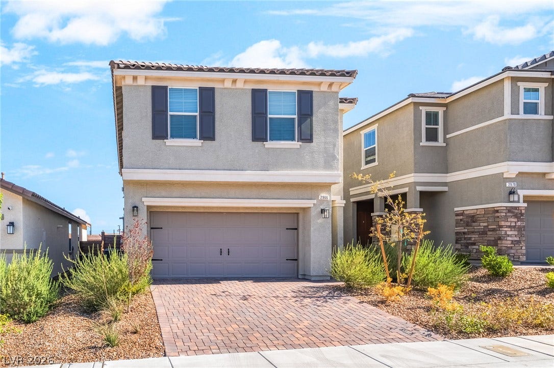 2966 Gallarate Drive, Henderson, NV 89044 A contemporary residence boasts a paver driveway, an attached garage, and striking window shutters.