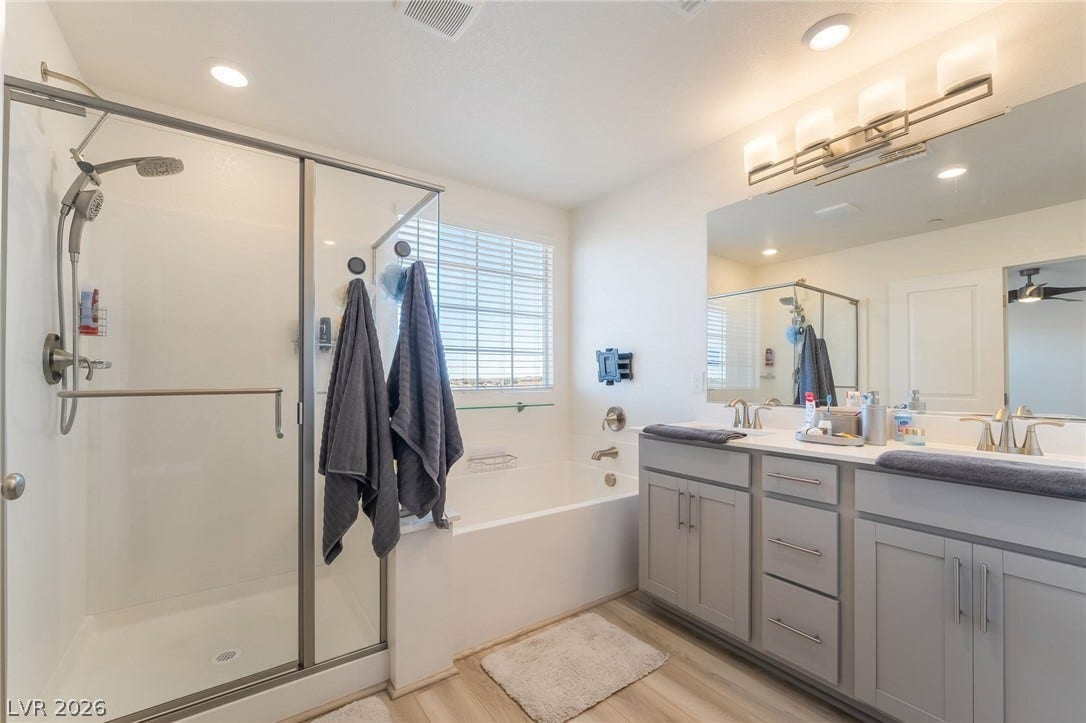 2966 Gallarate Drive, Henderson, NV 89044 Modern bathroom featuring a spacious shower, a soaking tub, and a dual vanity with ample storage.