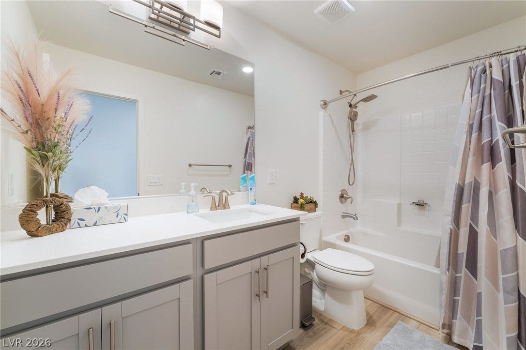 2966 Gallarate Drive, Henderson, NV 89044 A well-appointed bathroom offers a vanity with ample counter space and a classic tub-shower combination.