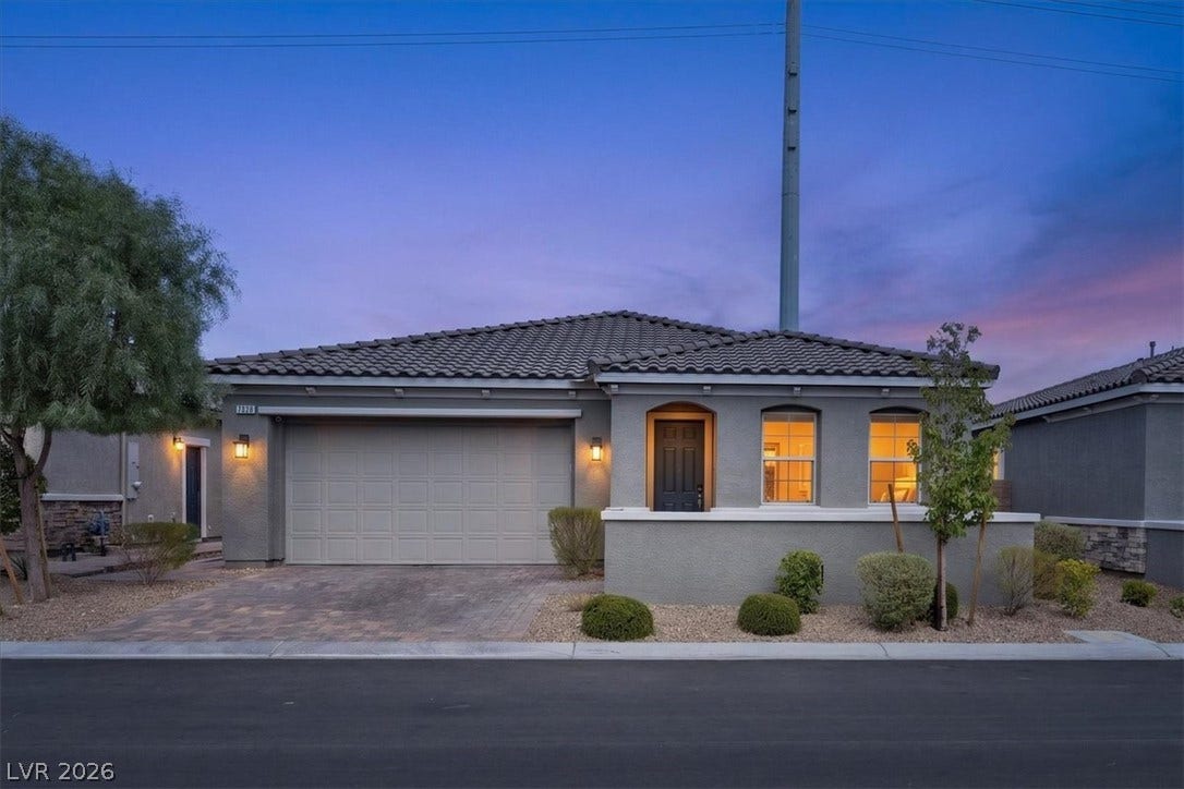 An inviting front entry welcomes you to this residence, complete with a paved driveway and low-maintenance landscaping.