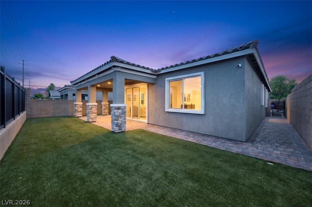 A well-maintained yard and covered patio create a perfect setting for outdoor enjoyment.