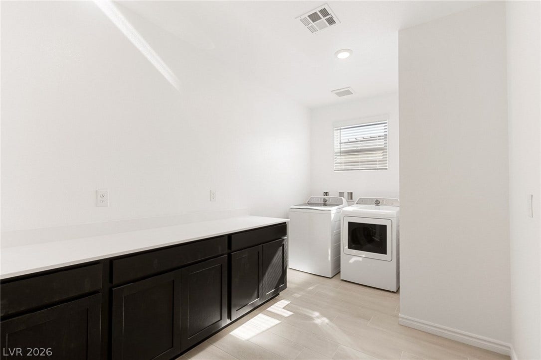 9986 Joshua Foothills Street, Las Vegas, NV 89178 Ample counter space and modern appliances streamline daily routines in this well-appointed laundry room.