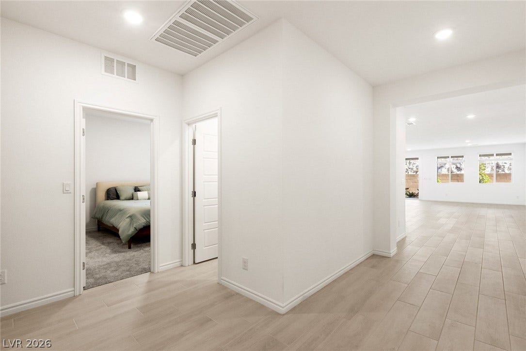 9986 Joshua Foothills Street, Las Vegas, NV 89178 Clean lines and light-toned tile flooring define this home's inviting hallway, leading to a well-lit living area.