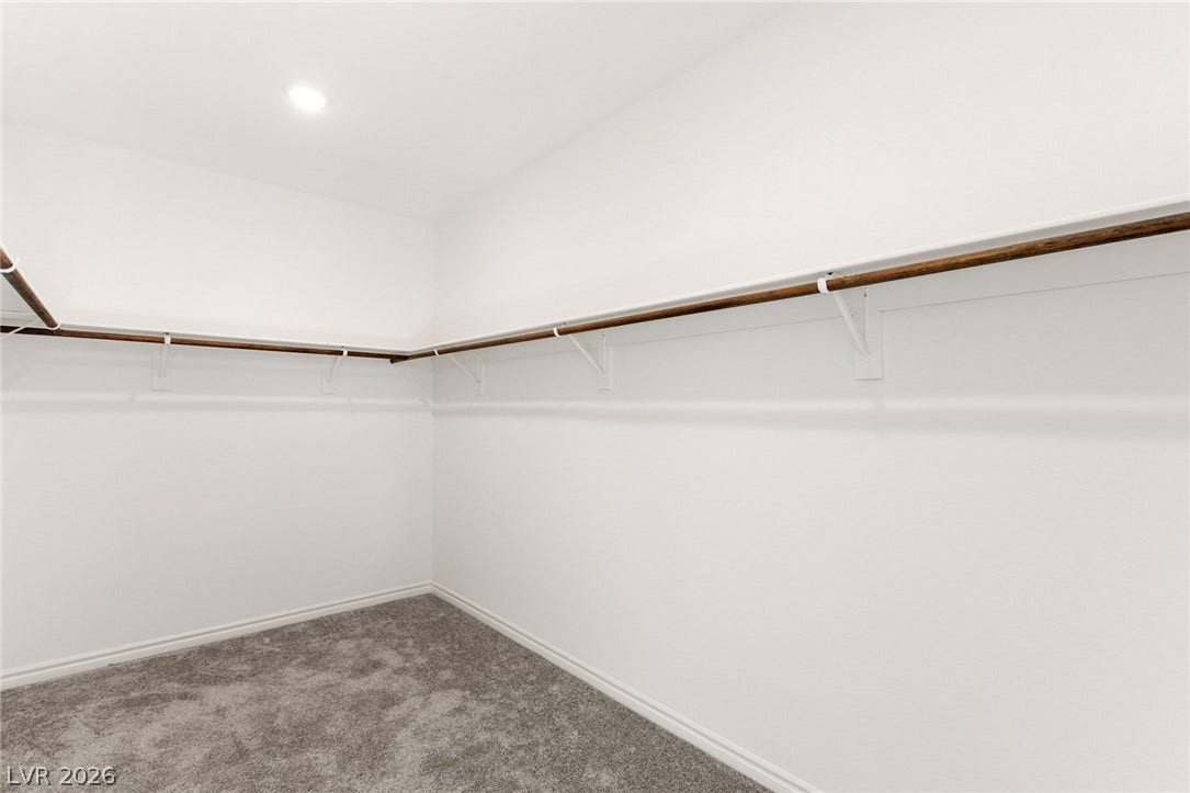 9986 Joshua Foothills Street, Las Vegas, NV 89178 A well-lit, generous closet with ample hanging space and soft carpeting provides organized storage.