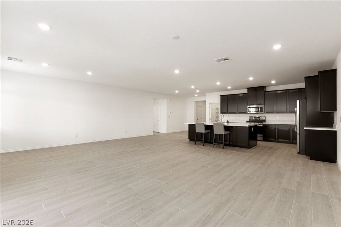 9986 Joshua Foothills Street, Las Vegas, NV 89178 An open concept living area transitions seamlessly into a sleek, well-appointed kitchen.