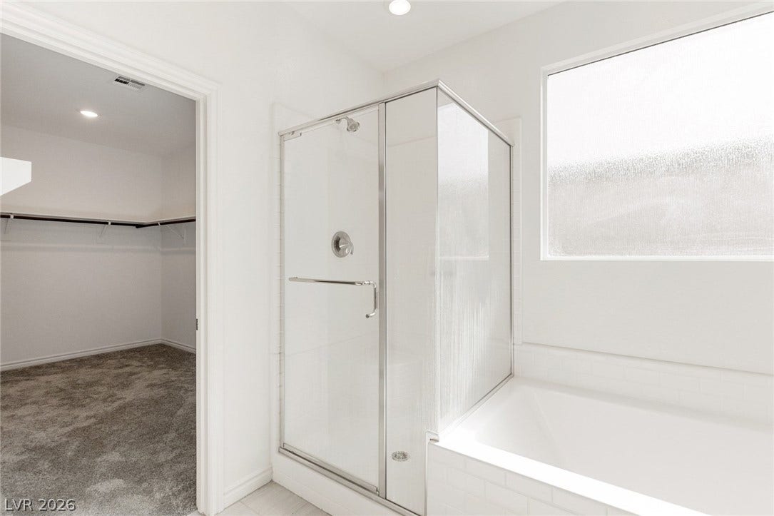 9986 Joshua Foothills Street, Las Vegas, NV 89178 A well-appointed bathroom features a pristine shower enclosure and an adjacent walk-in closet.