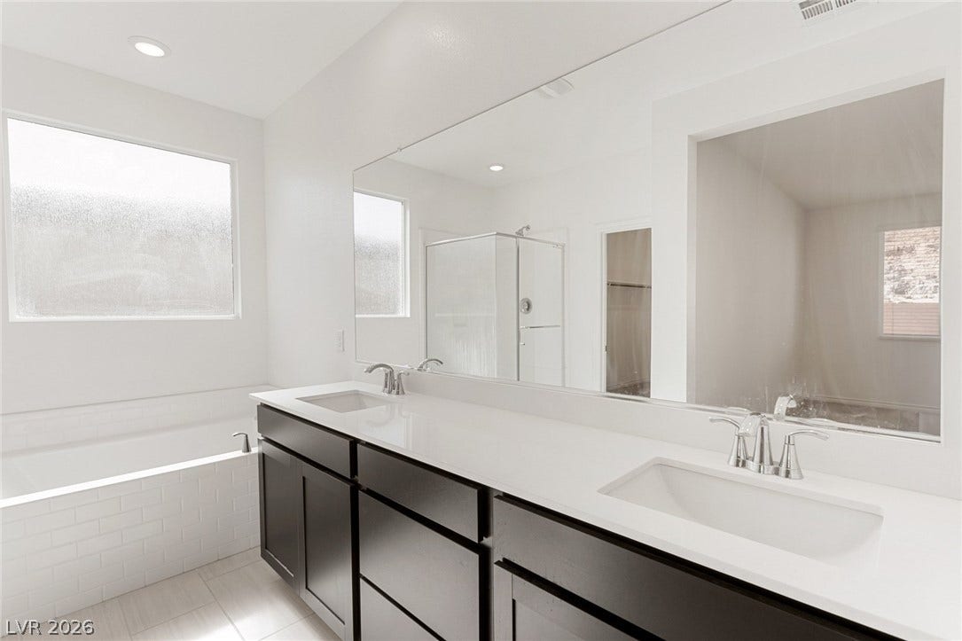 9986 Joshua Foothills Street, Las Vegas, NV 89178 Dual vanity with sleek, modern cabinetry and bright, tile flooring defines this tranquil bathroom space.