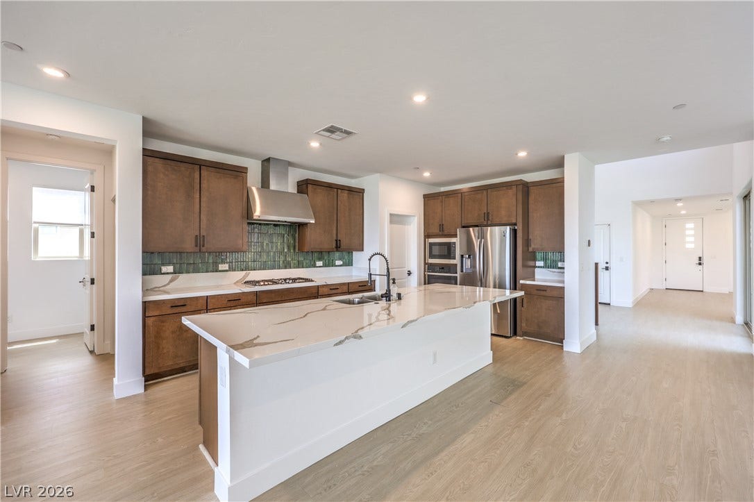 1984 Canyon Highlands Drive, Henderson, NV 89052 Culinary creations come to life in this kitchen, featuring an elegant island and stainless steel appliances.