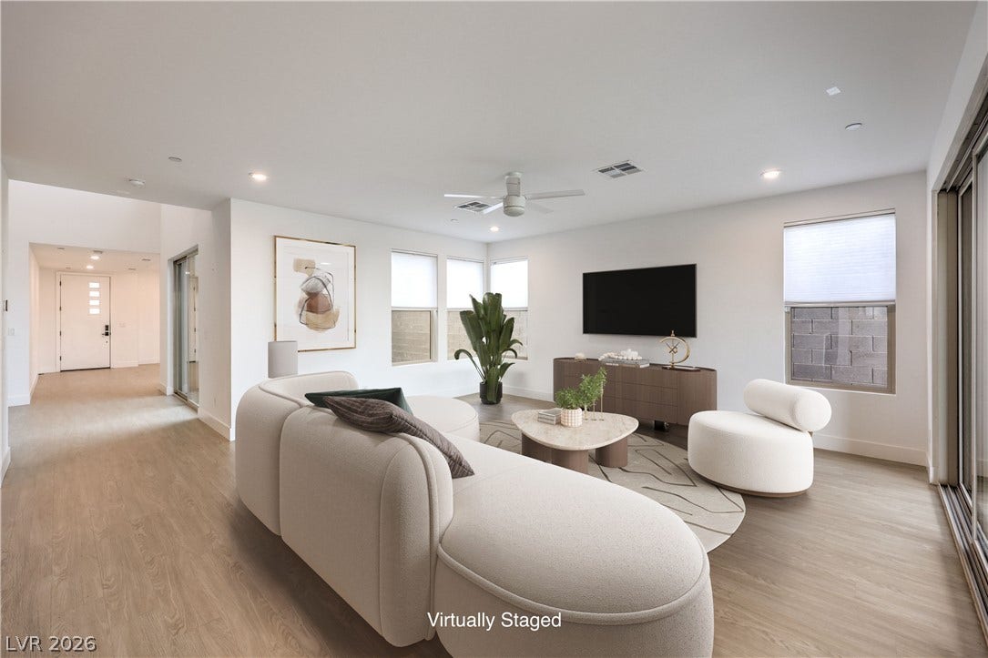 1984 Canyon Highlands Drive, Henderson, NV 89052 A well-lit living area features light wood flooring and a modern aesthetic, flowing into an inviting entry.