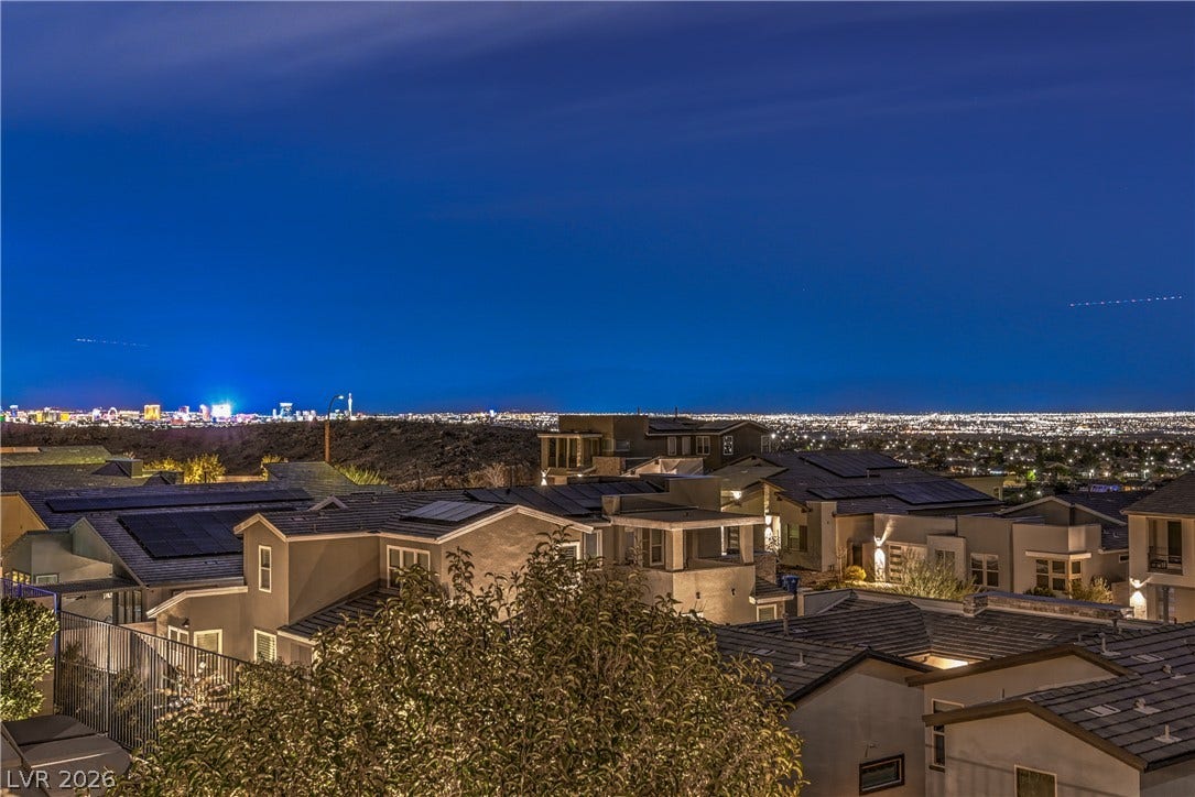 1984 Canyon Highlands Drive, Henderson, NV 89052 City lights sparkle against the night sky, offering a captivating view from this elevated neighborhood.