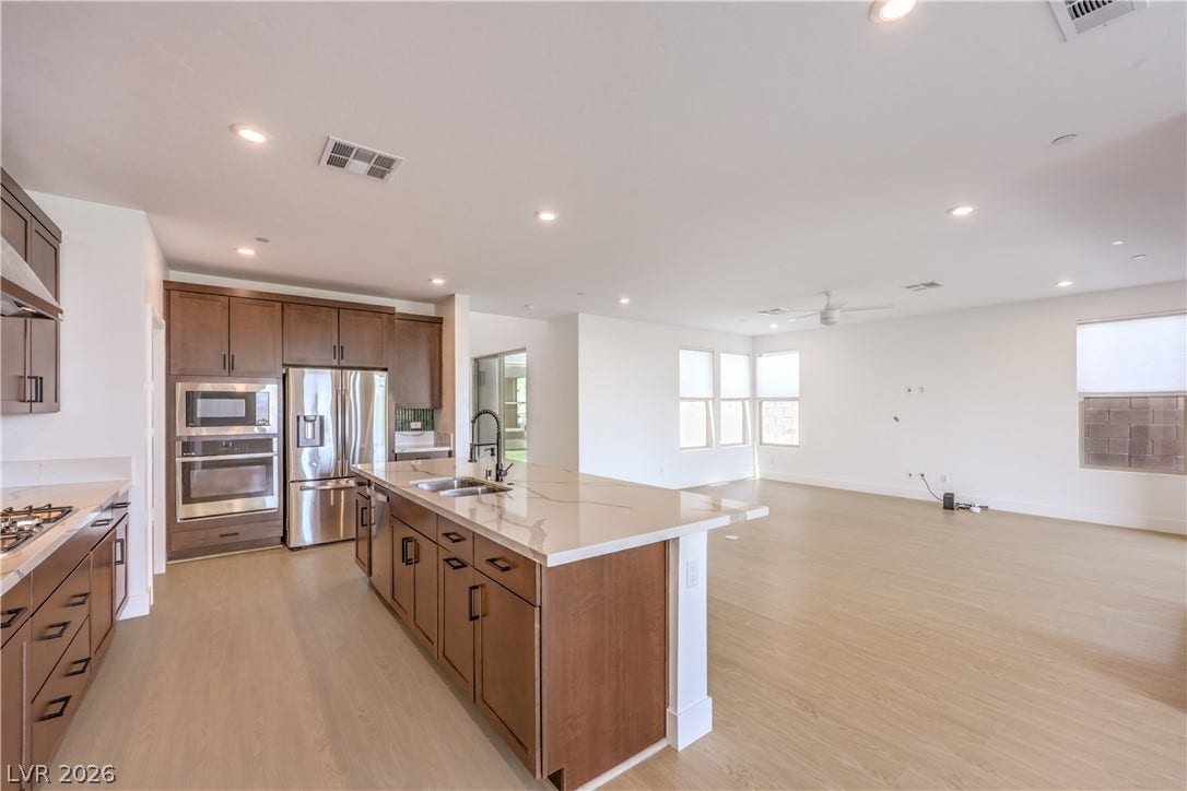 1984 Canyon Highlands Drive, Henderson, NV 89052 An open concept living area seamlessly connects a chef-inspired kitchen featuring a large island with ample counter space and a living room with generous natural light.
