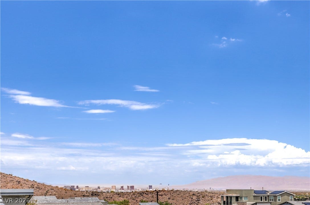 1984 Canyon Highlands Drive, Henderson, NV 89052 A commanding vantage reveals distant cityscapes and expansive desert terrain under a vast sky.