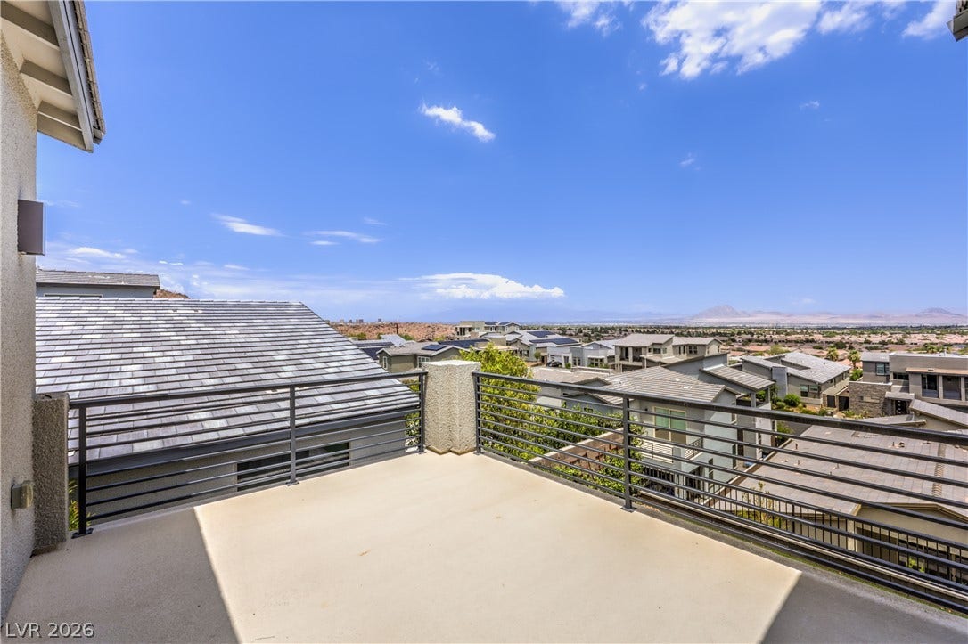 1984 Canyon Highlands Drive, Henderson, NV 89052 A spacious outdoor deck with modern railings offers panoramic views of the surrounding neighborhood and distant mountains.