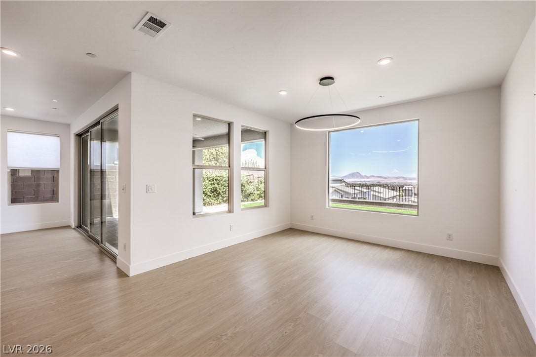 1984 Canyon Highlands Drive, Henderson, NV 89052 Floor-to-ceiling windows and sliding glass doors illuminate this versatile room with serene views.