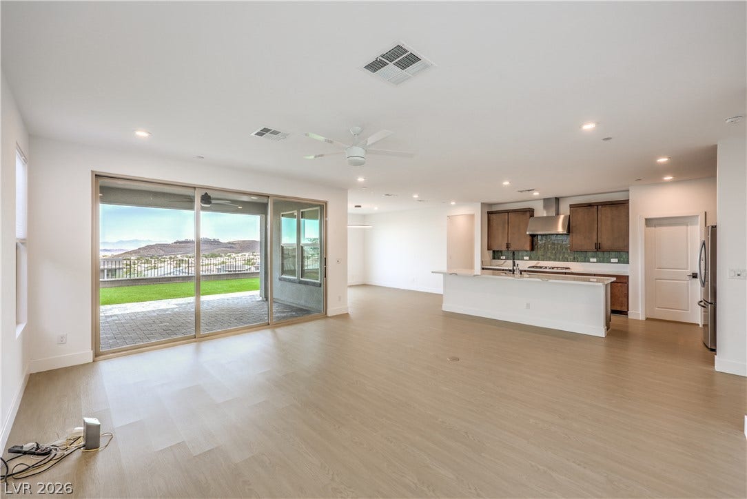 1984 Canyon Highlands Drive, Henderson, NV 89052 An open-concept living area flows seamlessly into a modern kitchen, with a private patio overlooking a scenic hillside.