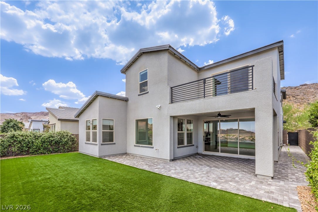 1984 Canyon Highlands Drive, Henderson, NV 89052 A well-maintained synthetic lawn and spacious paver patio complement this modern home's exterior.