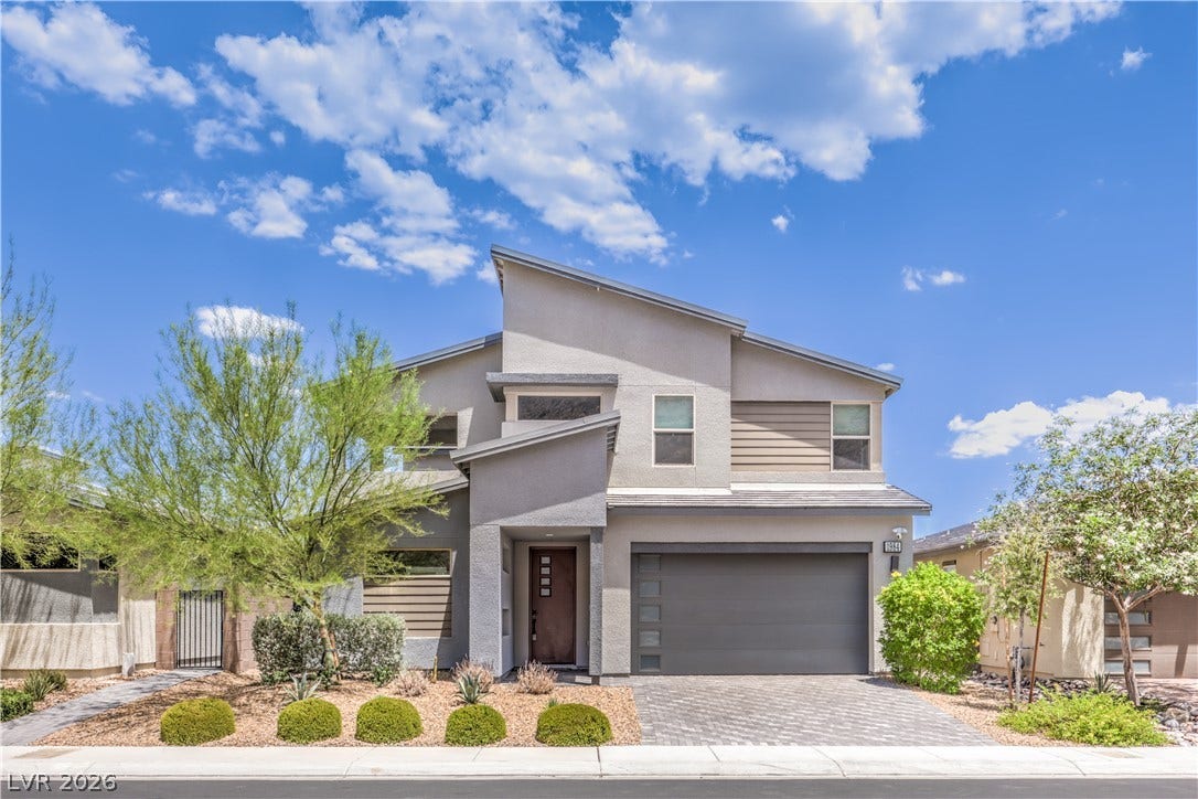1984 Canyon Highlands Drive, Henderson, NV 89052 A modern facade with striking architectural lines and an integrated garage presents inviting curb appeal.